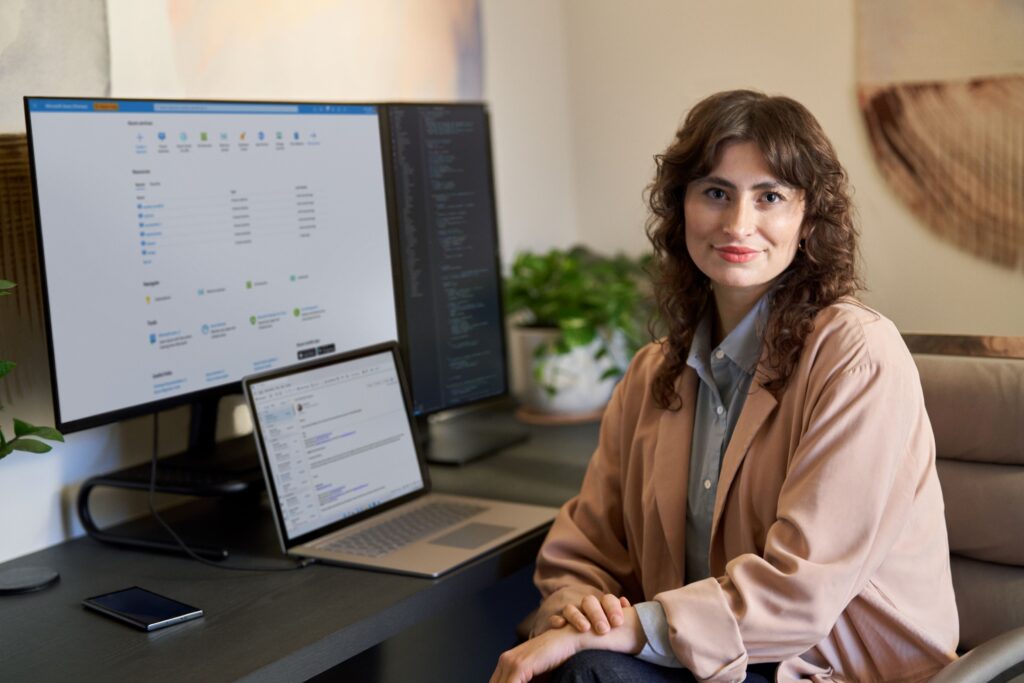a person sitting at a desk in front of a computer